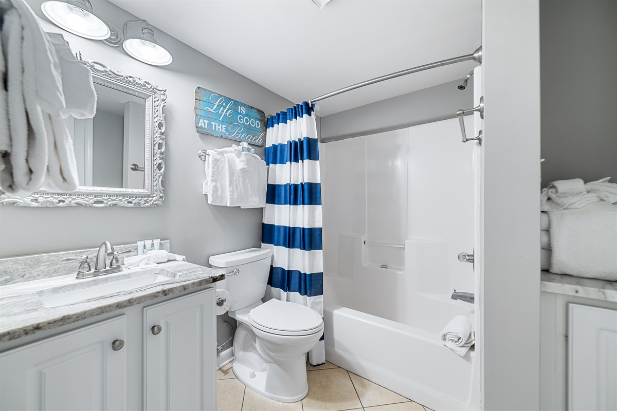 Freshly updated bathroom featuring a shower/tub combination, ample vanity space, and modern fixtures.