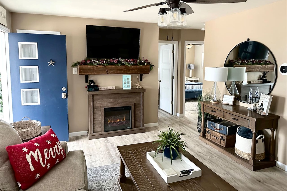 Nothing beats the early glow of the holidays! In November, the living area is transformed into a warm, seasonal retreat featuring a cozy fireplace, holiday greenery on the mantle, and festive accents that make the space feel like home for the holiday.