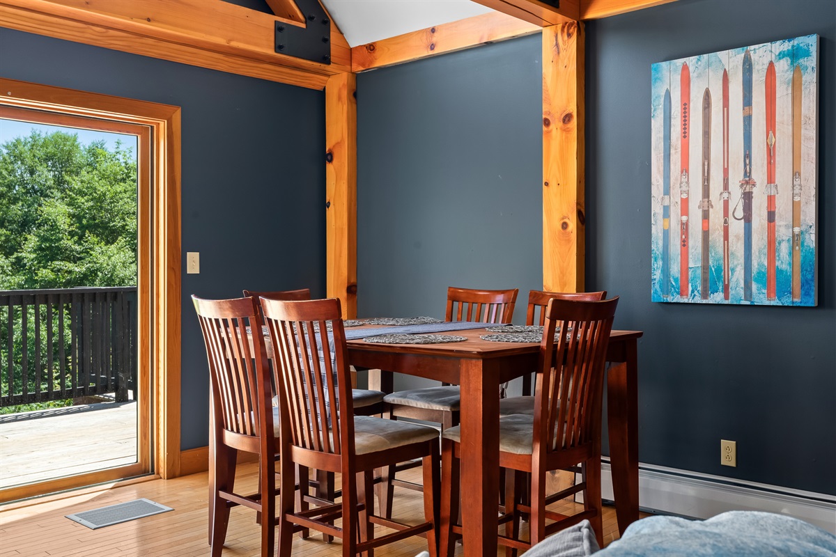 Share slow meals and mountain stories in a cozy dining nook framed by rustic charm and peaceful views.