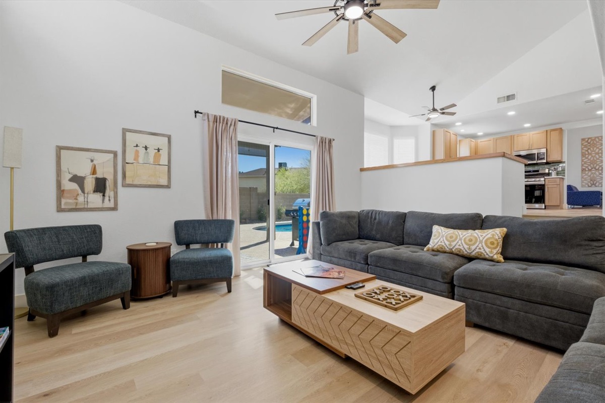 Large living room has an extra large sectional, individual chairs, big screen smart TV, board games, two different areas to charge your devices.