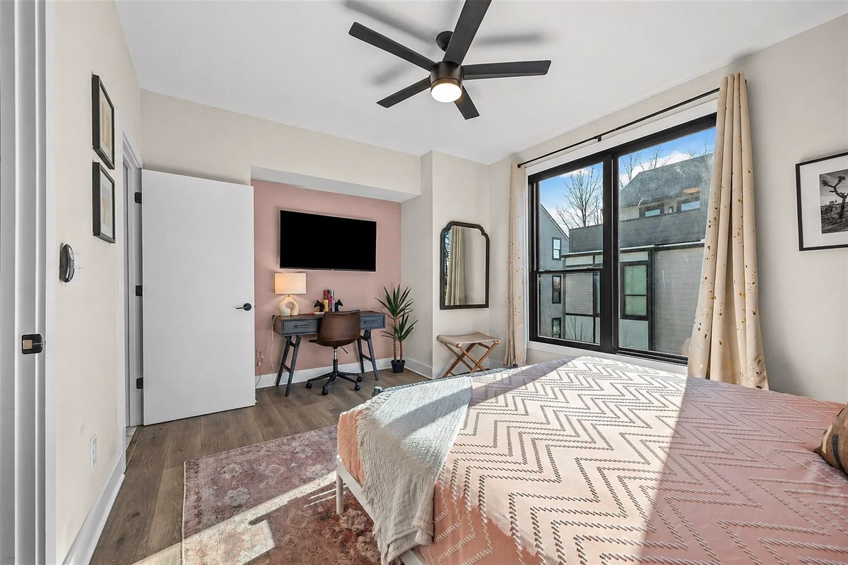 Retreat to the third-floor primary suite, complete with a plush king bed, private ensuite bathroom, and wall-mounted TV&mdash;designed with fresh linens and modern, elevated finishes.