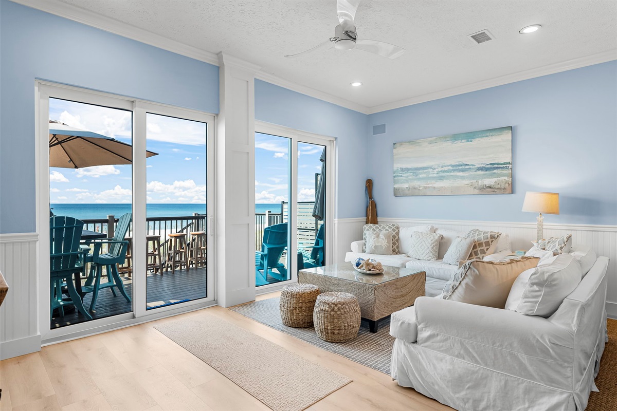 Relax and soak in the view from the first-floor living room, where comfort meets the sea