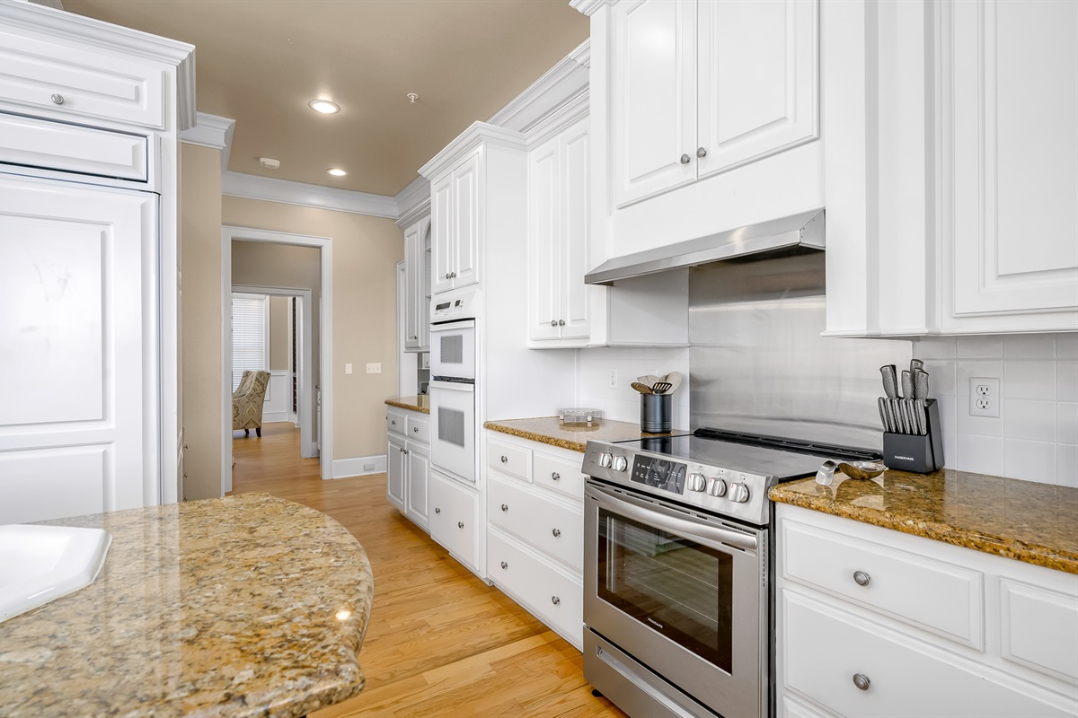 Kitchen leads to butler’s pantry connecting to wine room