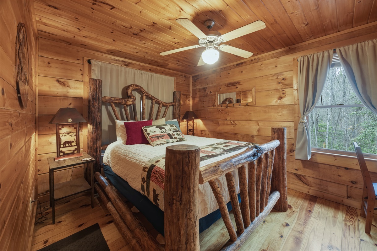 Queen bed in bedroom with direct access to bathroom and work area