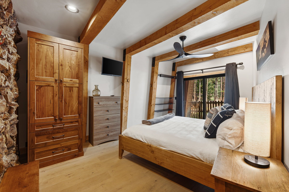 Lower level Primary Suite with King bed, tv, private ground-level patio. 