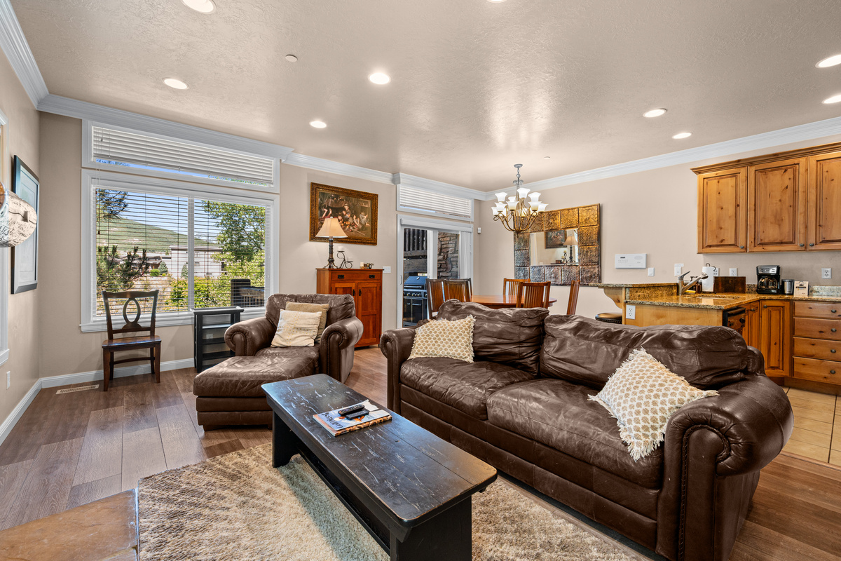 Bright open-concept living area with comfortable seating and seamless flow into the kitchen and dining spaces.
