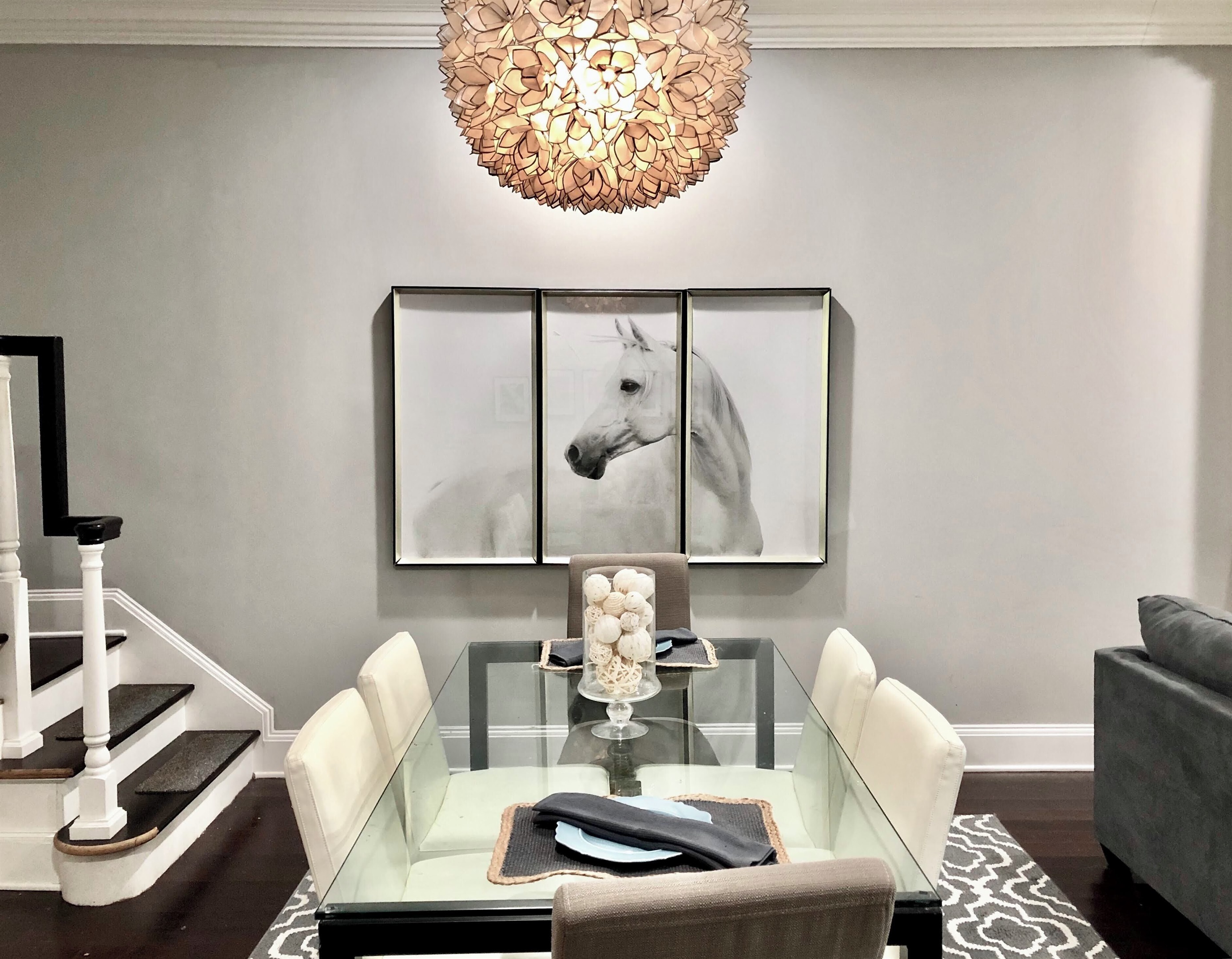 Gather around this sleek glass table for meals, games, or conversation—plush seating for six under a stunning designer light fixture.