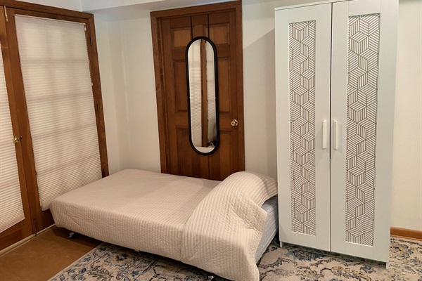 The trundle is a regular height (10 in) mattress. The door pictured leads to a utility room, which remains locked.