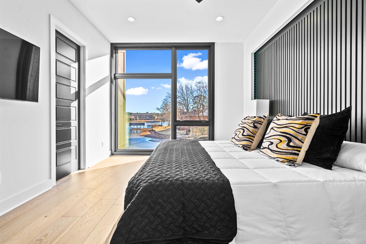 Wake up to peaceful views in this stunning king bedroom, styled with modern furnishings and soft, soothing tones for a truly relaxing escape.