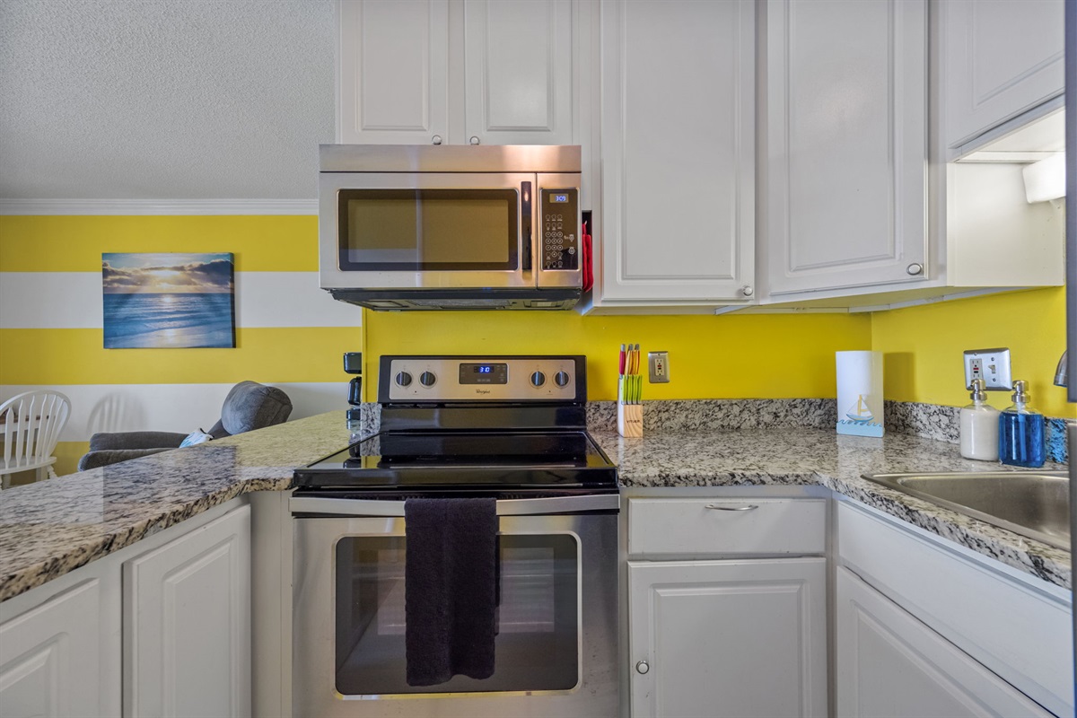 Fully equipped kitchen with stove, microwave, and plenty of counter space for easy meal prep