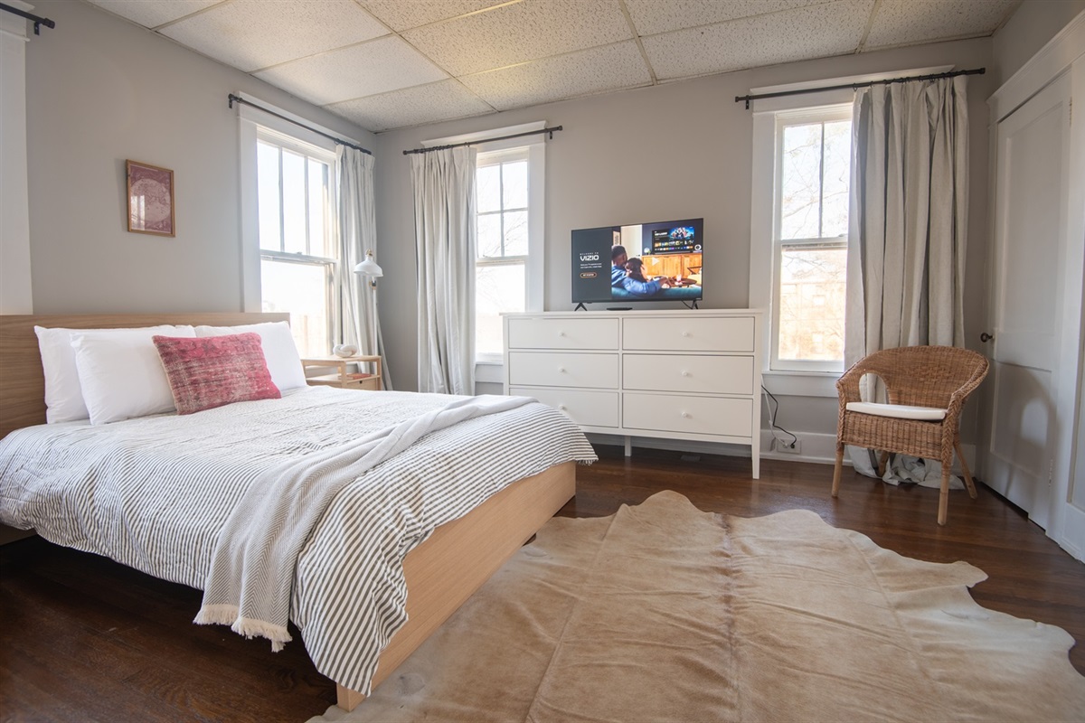Cozy bedroom with queen bed and elegant decor.