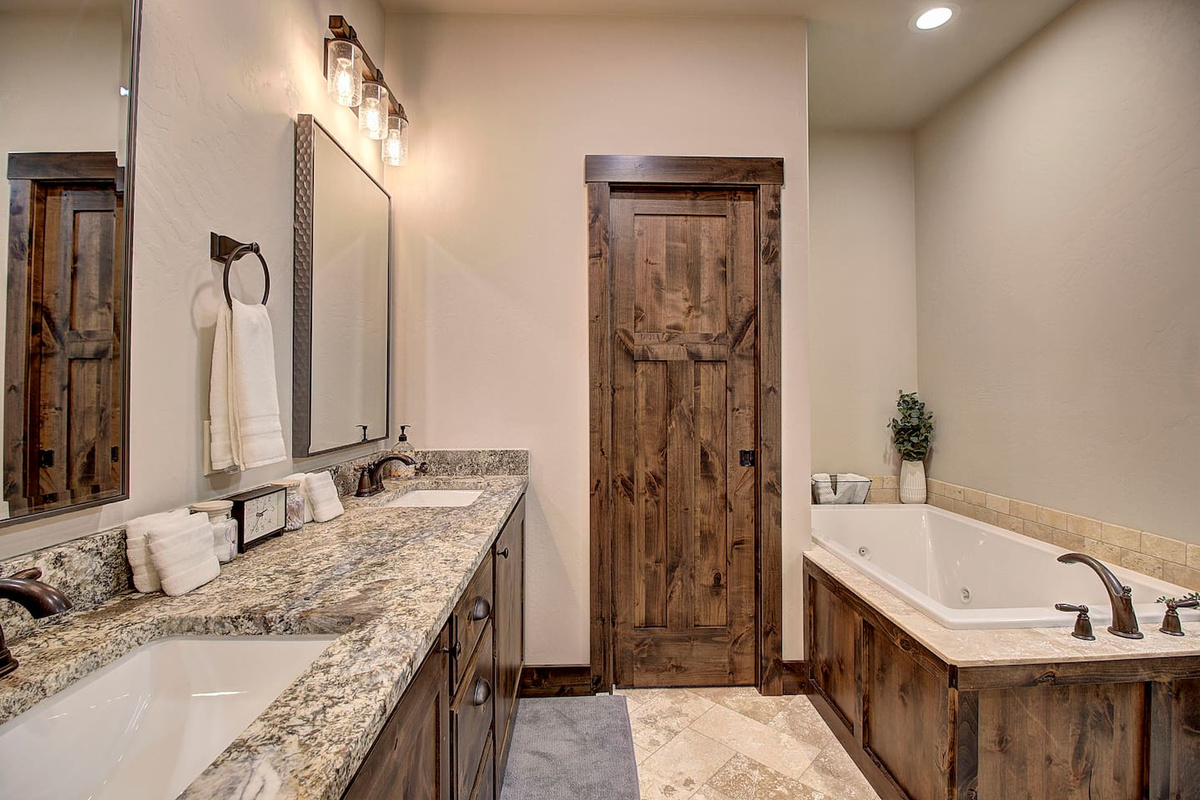 Enjoy a relaxing soak in the large jetted tub with warm, natural finishes.