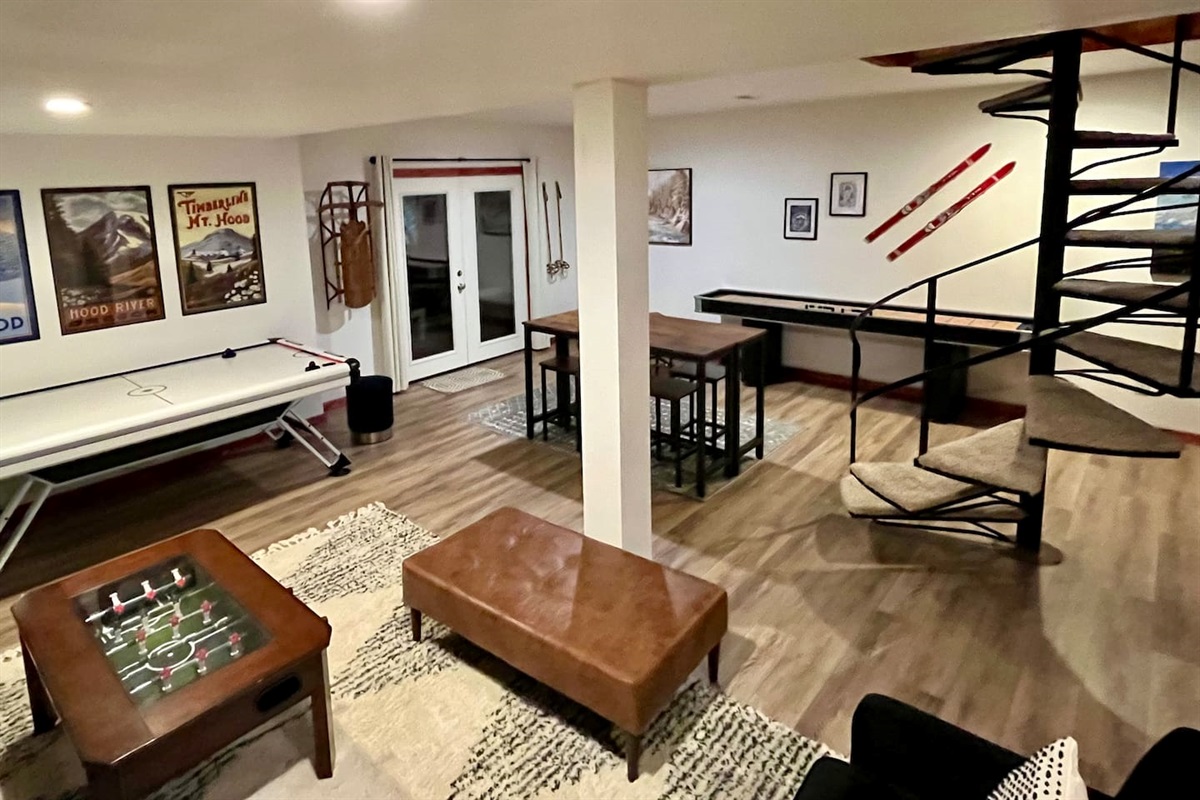 Mount Hood and Winter Sports Themed Game Room with Wood Burning Fireplace and Large Smart TV.