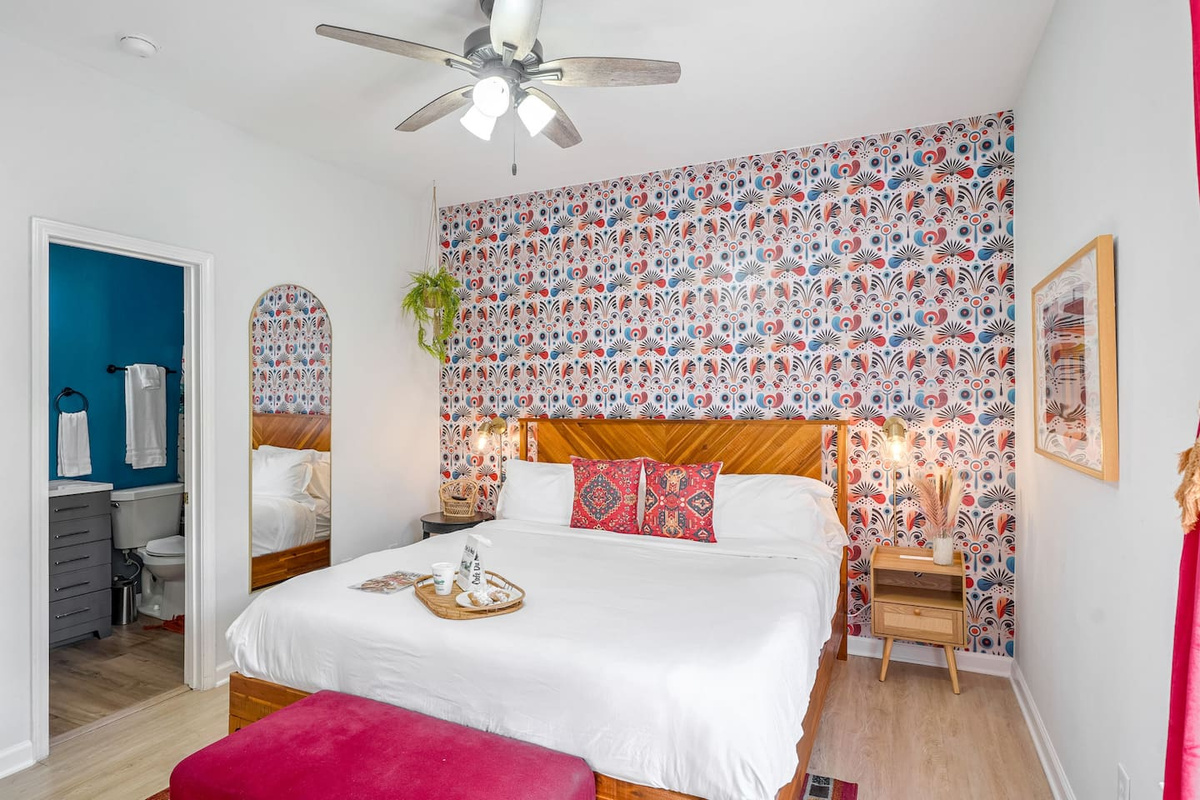 Relax in the downstairs master featuring a premium king bed, smart TV, and en suite bath