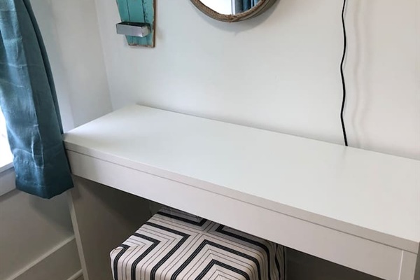 The ultimate flexible space!  This cozy bunk room features two Queen beds and a dedicated workspace with a desk and Smart TV. Perfect for remote work, gaming, or a quiet kid’s retreat—combining 30A comfort with functional utility.