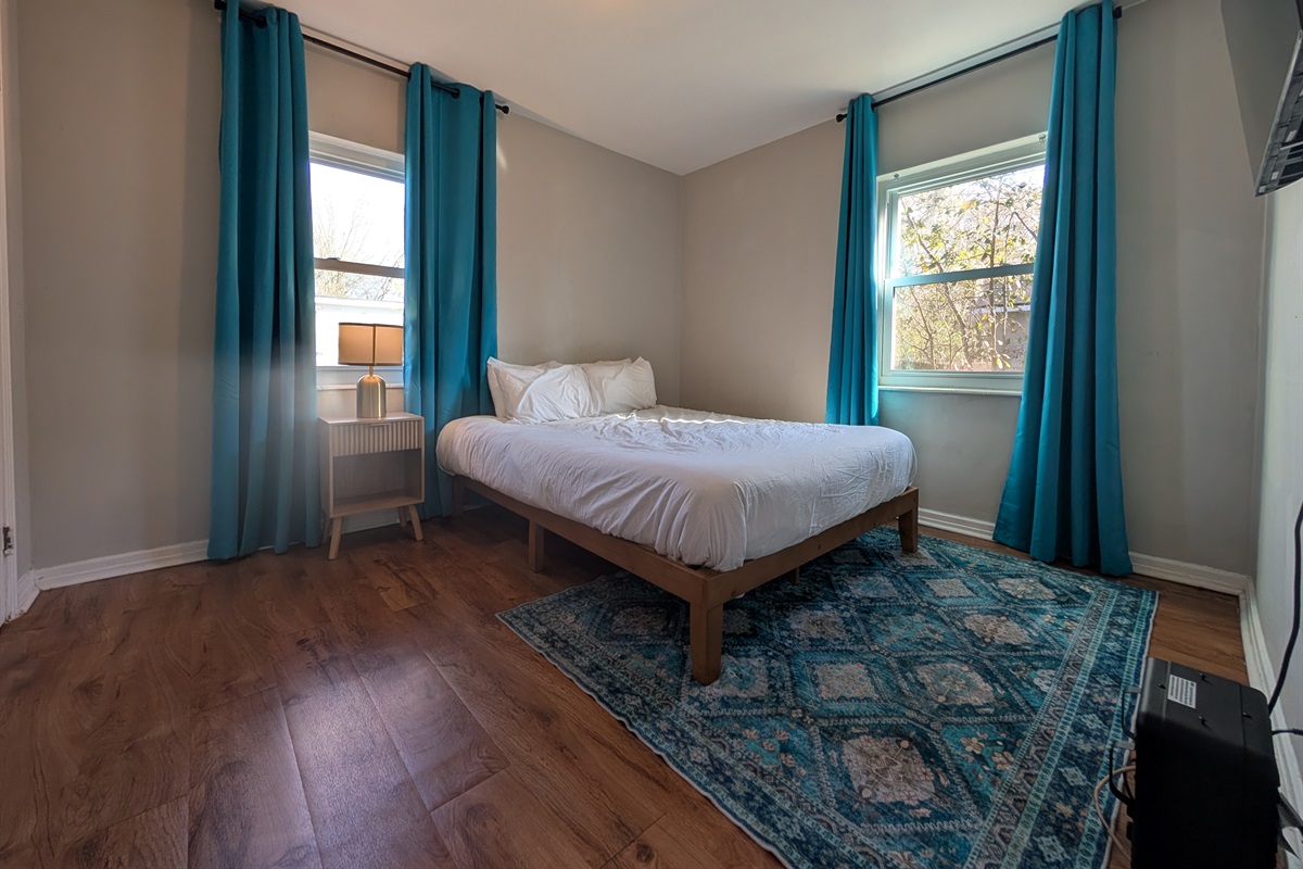 Guest bedroom with queen bed and smart TV