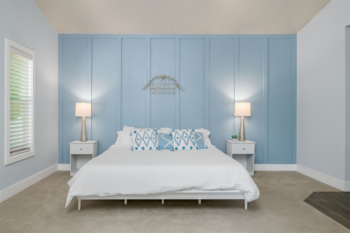 Stretch out in the spacious primary bedroom with a king bed, soft lighting, and room for a Pack ‘n Play for family comfort.