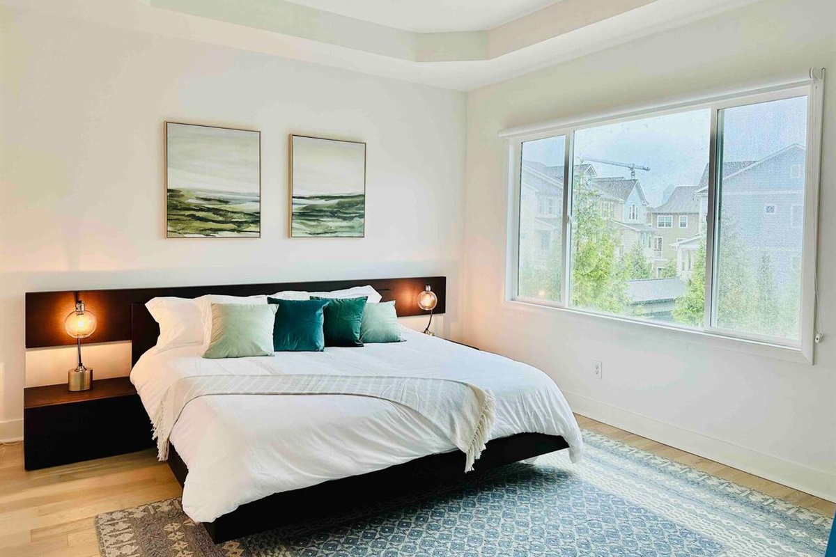 Sleep in style with a view in the master with ensuite spa-style bathroom. This white-themed bedroom is the perfect place to relax and unwind.