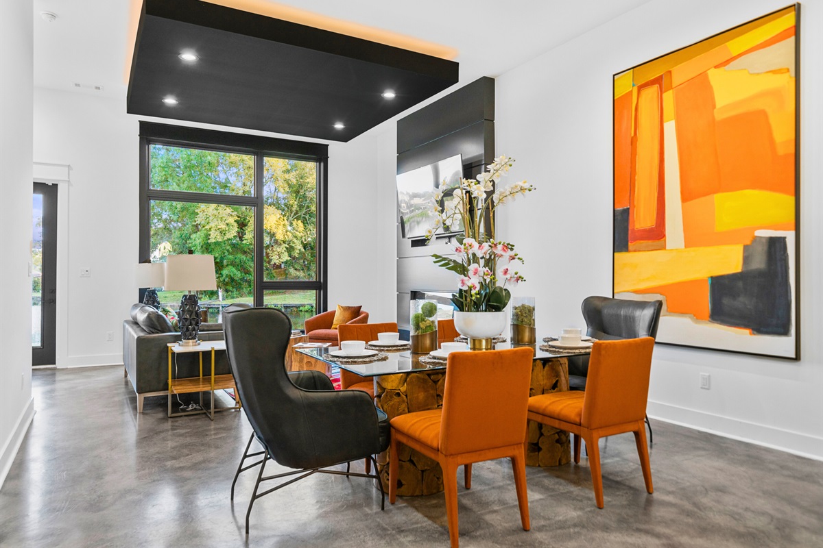 A stylish dining space with bold art, vibrant seating, and a modern flair that’s perfect for memorable meals or lively gatherings.