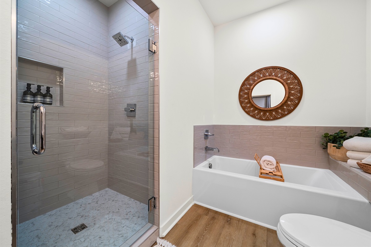 Walk-in shower with modern tile design and high-end finishes.