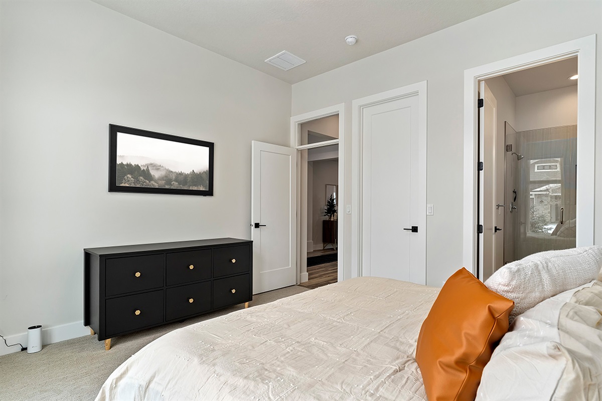 Another comfortable guest bedroom designed for a restful night’s sleep.