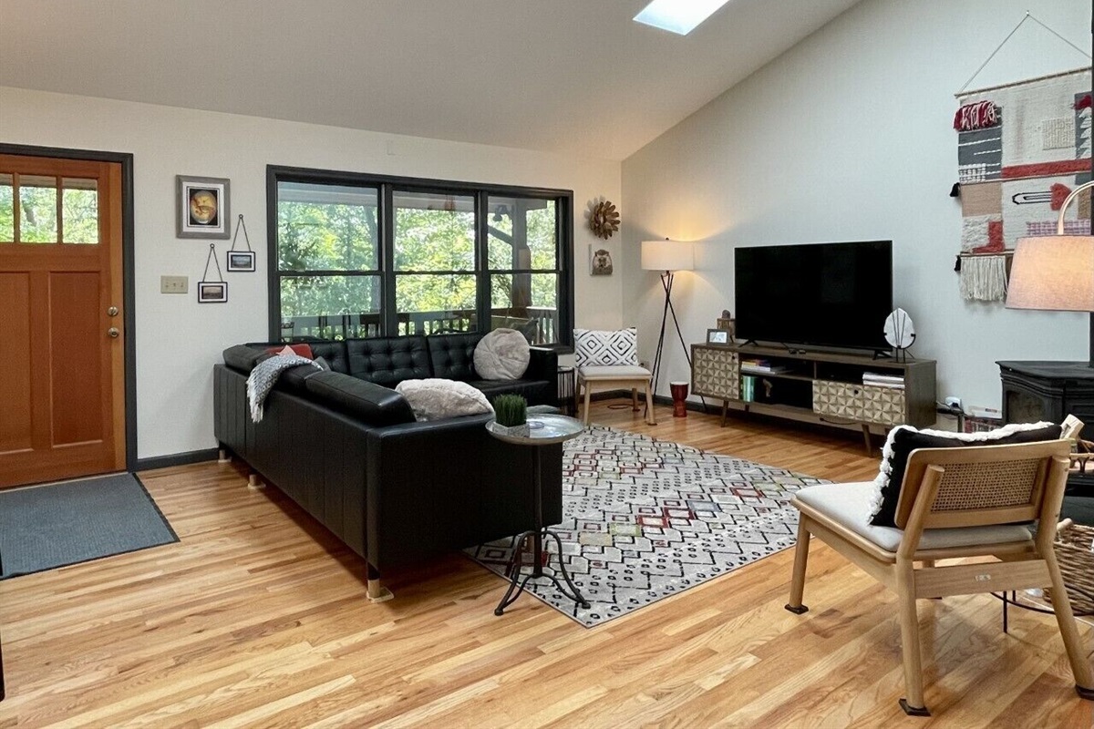 Large living area with smart tv, woodstove, and creature comforts