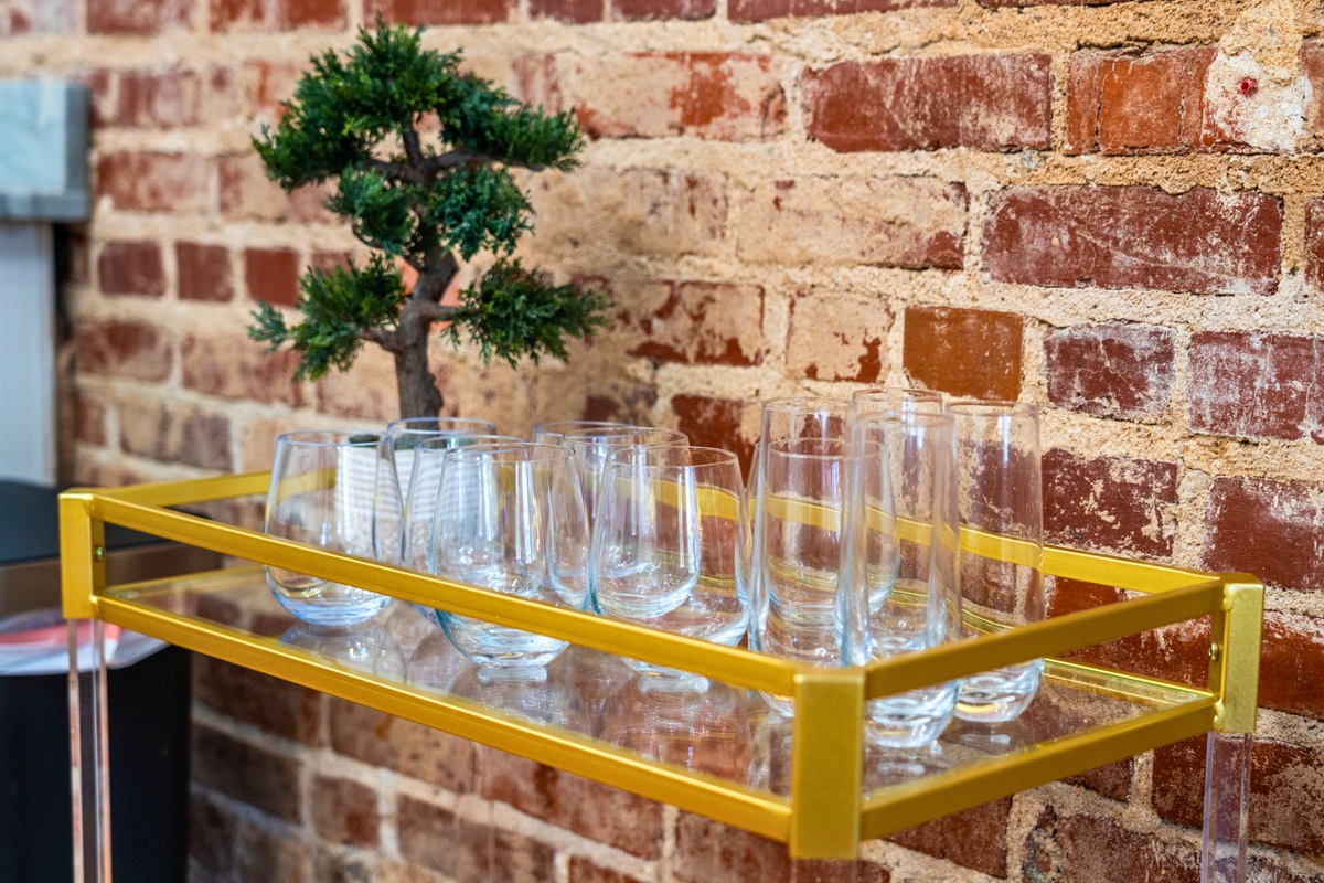 This stylish bar cart stocked with glassware adds a touch of elegance to your dining experience.