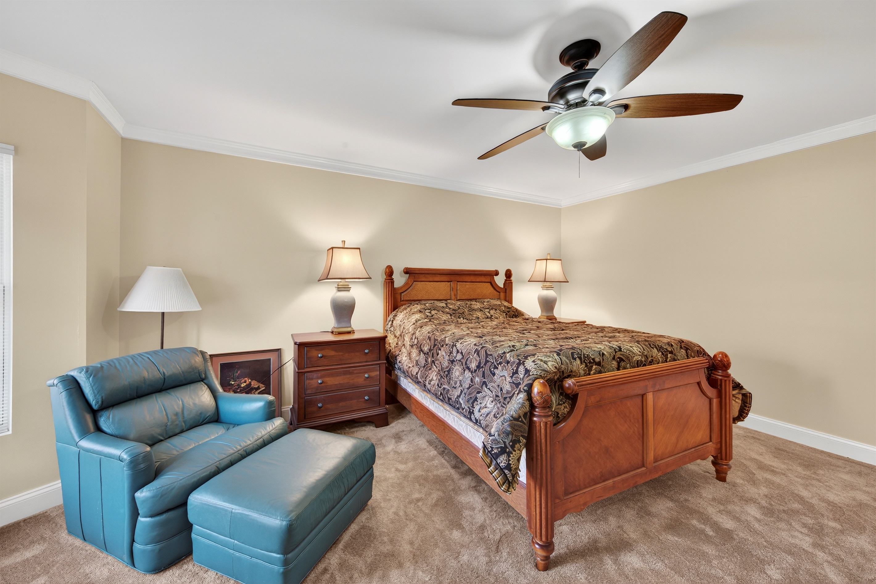 Cozy bedroom with a comfortable bed and a quiet reading corner.