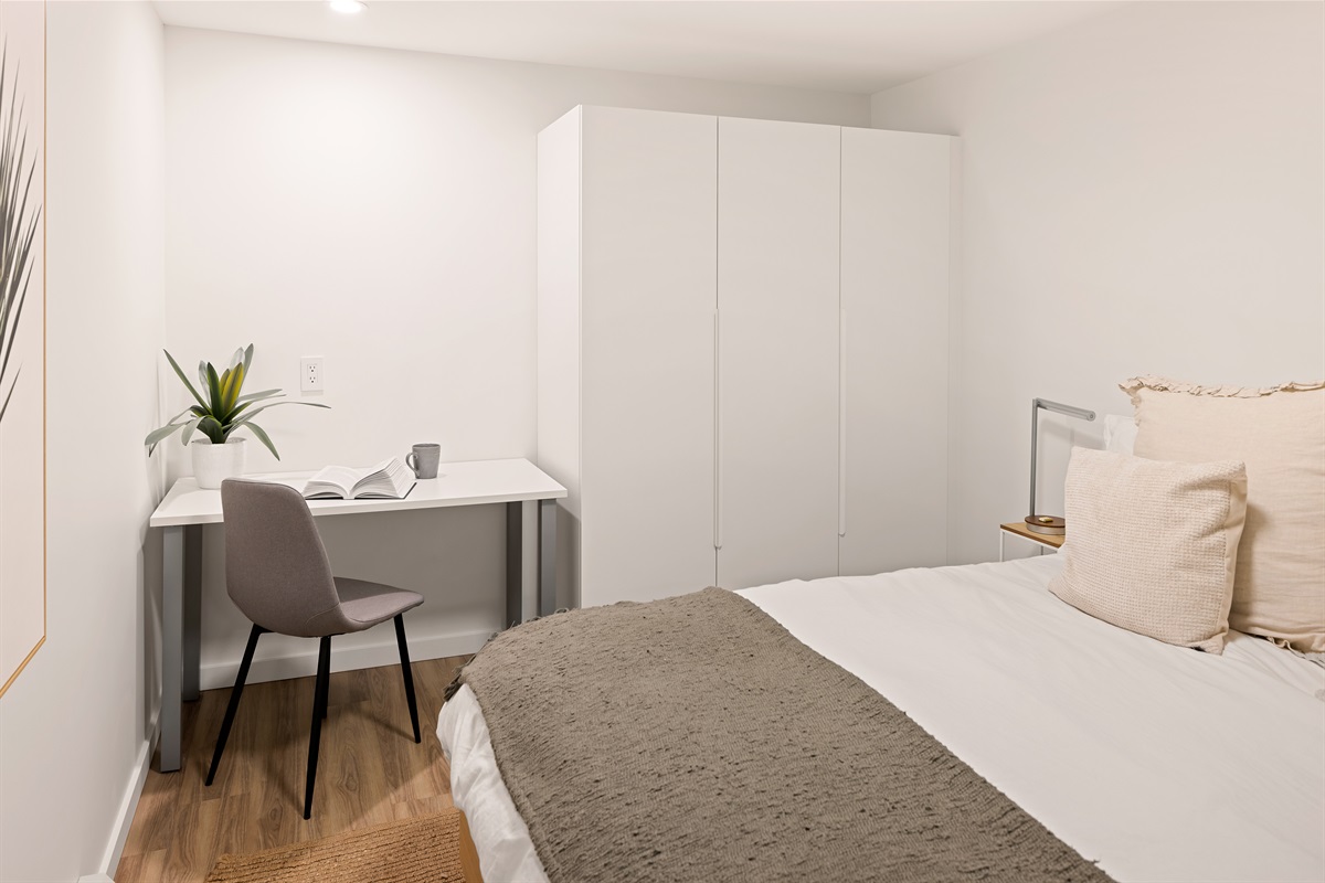 Primary bedroom workspace with desk and wardrobe storage — ideal for focused work or longer stays.