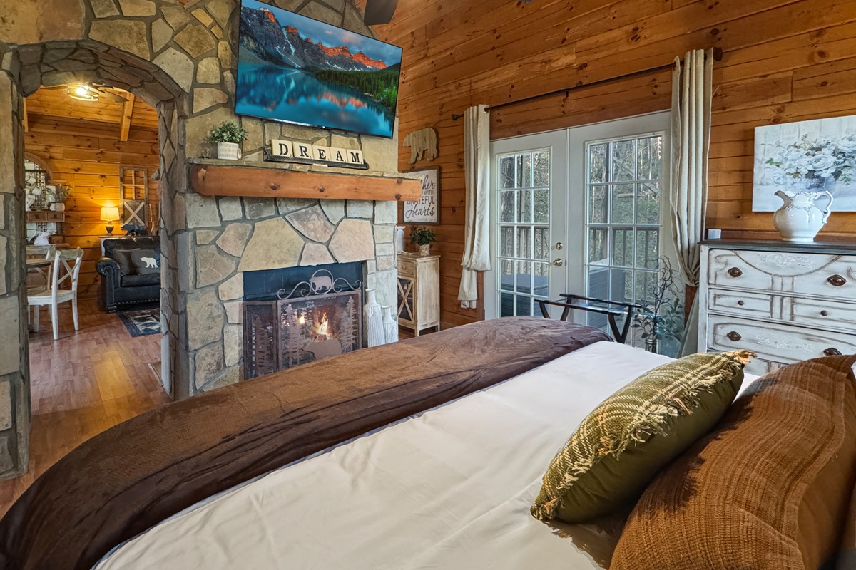 Wind down in bed with a favorite show and the soft glow of the fireplace