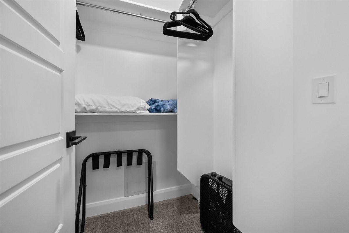Walk-in closet with ample storage for luggage and gear.