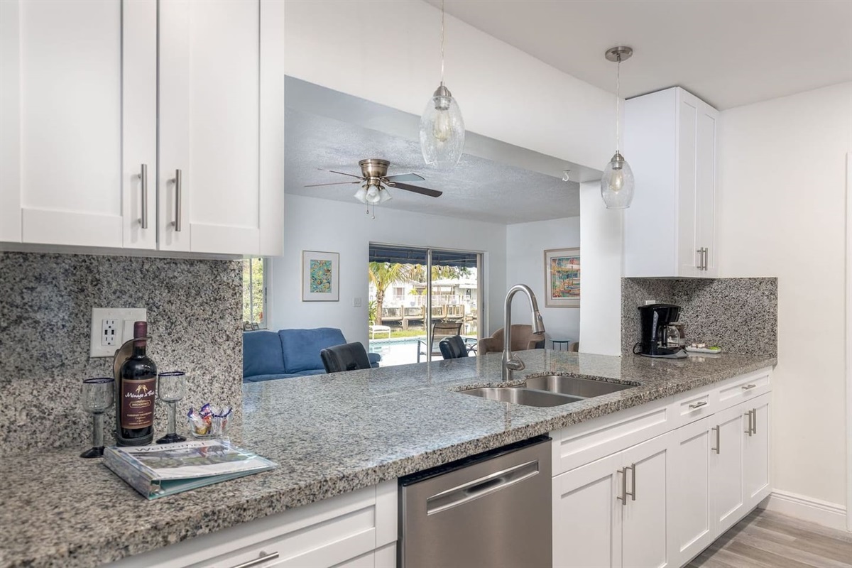 Enjoy the open-concept ambiance of this house and incredible views of Bahama Canal.Modern kitchen has granite counters, gas range, stainless steel appliances, dishwasher,minimalist glass-pendant chandelier lighting. 