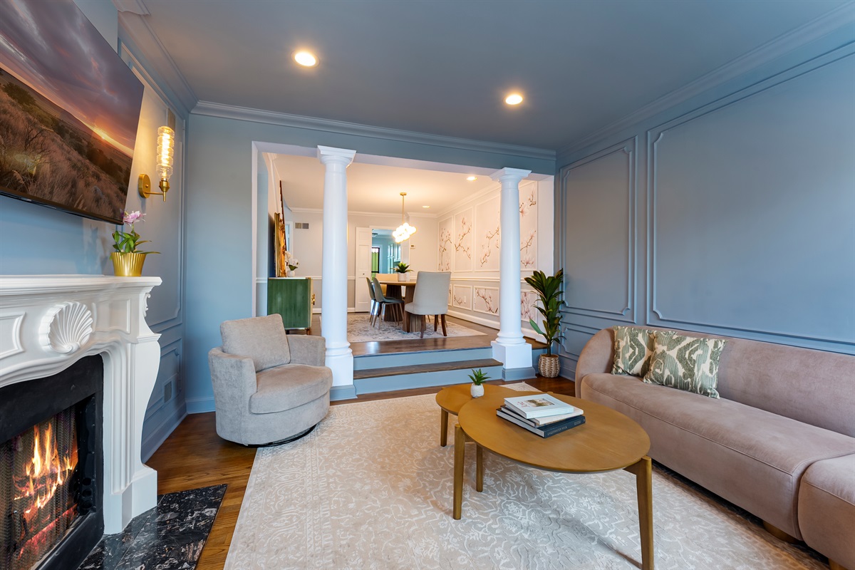 Sophisticated living space with decorative fireplace, detailed millwork, and chic furnishings—perfect for a stylish DC stay.