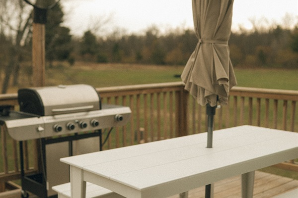 Outdoor seating and propane gas grill on deck