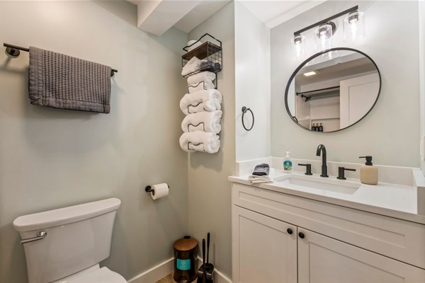 Full bathroom along the hallway with large shower, vanity, and storage.