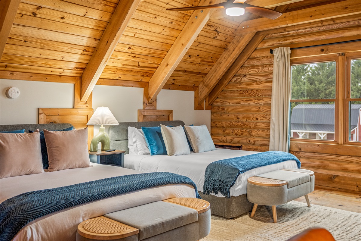 The loft suite sleeps your group with style featuring soaring wood ceilings, multiple queen beds, and that tucked-away feel that makes the whole floor feel like your own.