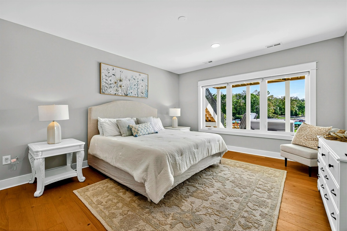 Guests will feel spoiled in this lower level king suite! Our high-end Restoration Hardware signature collection bed is dressed with a thick luxury white comforter that exudes a timeless elegance. We have layered the bedding for comfort and beauty! 