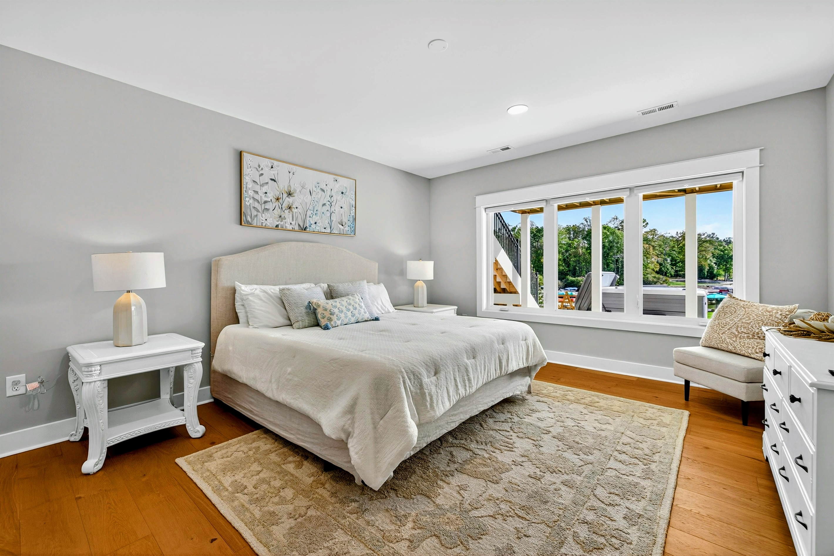 Guests will feel spoiled in this lower level king suite! Our high-end Restoration Hardware signature collection bed is dressed with a thick luxury white comforter that exudes a timeless elegance. We have layered the bedding for comfort and beauty! 