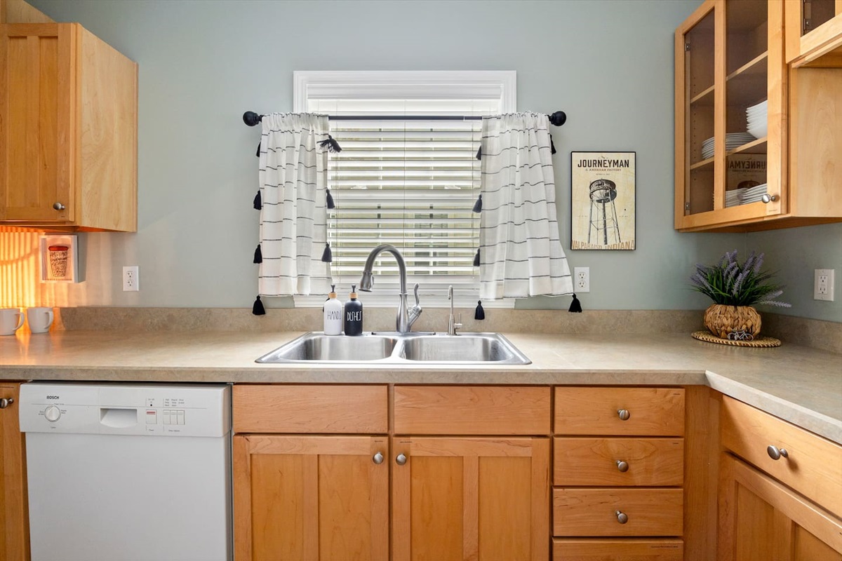 Bright galley kitchen with ample workspace. Reverse Osmosis filtered water available at sink and fridge. 