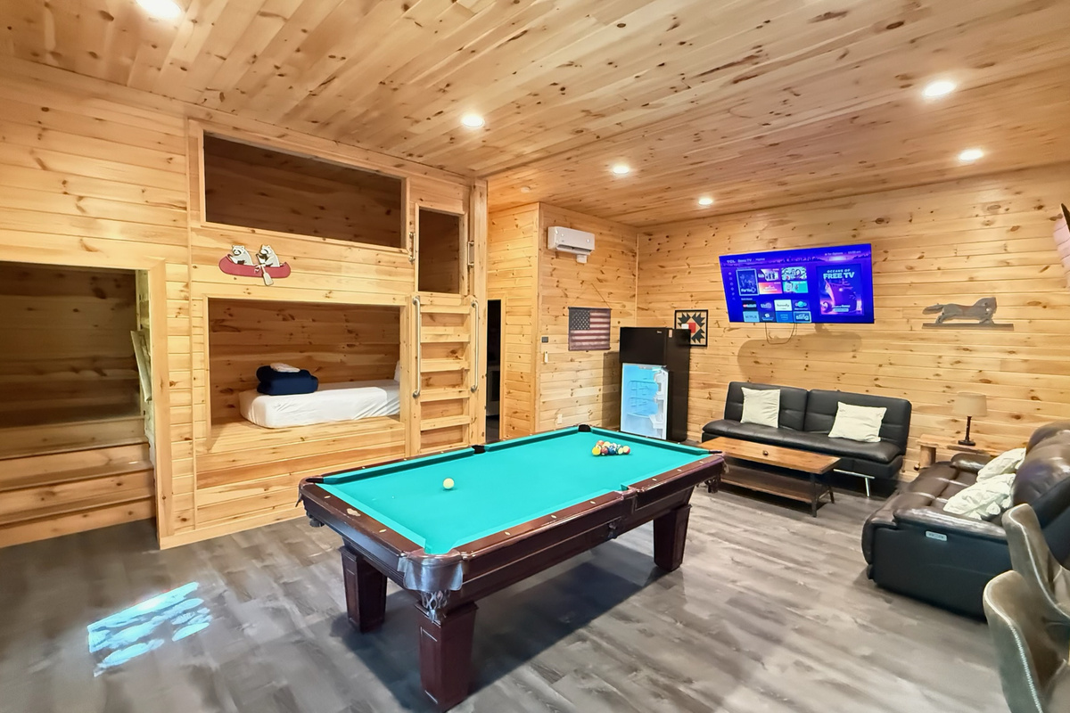 A fun-filled game room with pool table, TVs, and plenty of room to gather.