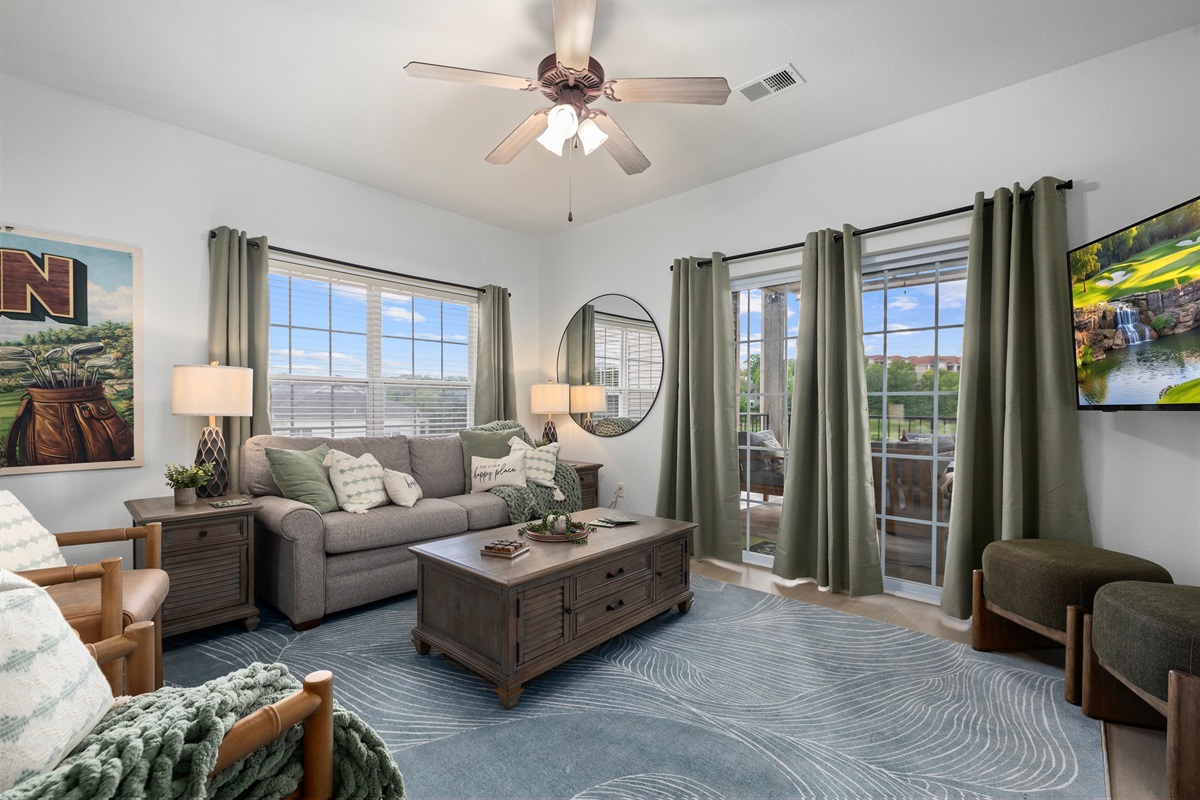 Back out in the main living room, lots of natural light, places to sit and gather and access to the deck with a view!