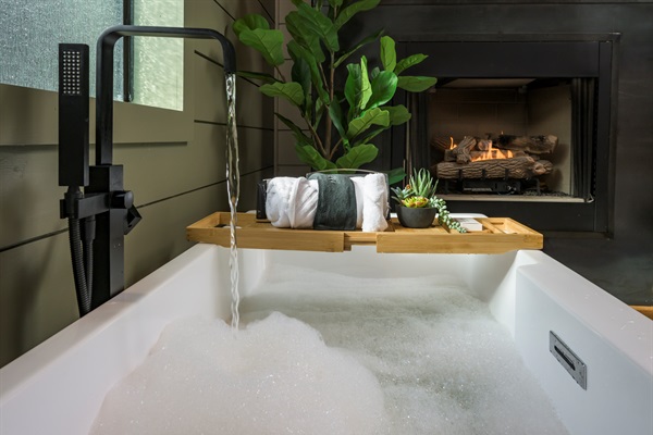 Soak, sip, and unwind — a deep tub by the fire sets the scene for pure relaxation and romantic evenings