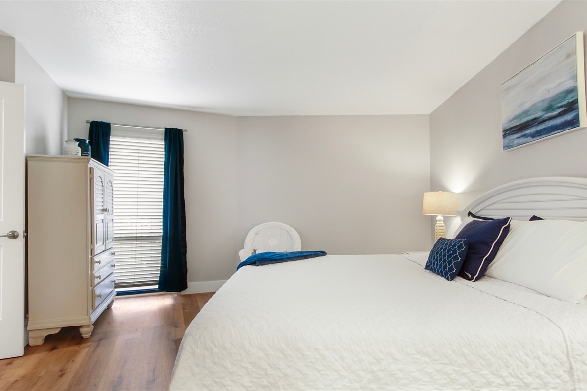 Main bedroom with king bed, ensuite bathroom, smart TV and clothing storage