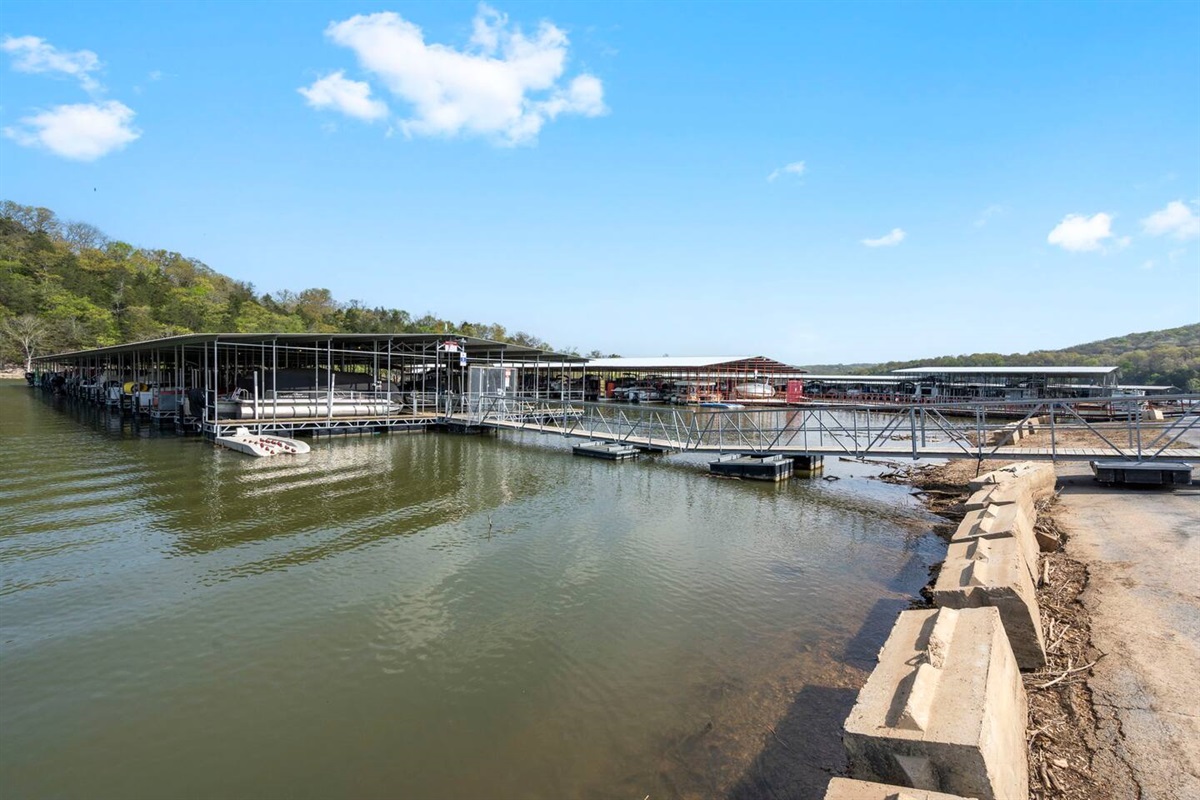 Peaceful marina dock with calm waters and blue skies.  Boat slips and boat rentals are available.
