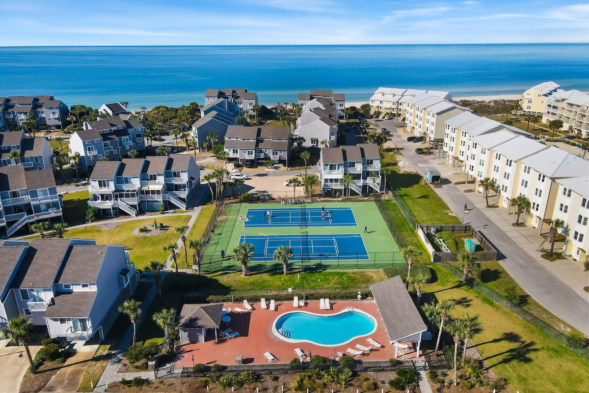 Your community from the  air: Gulf- front pool,  pickleball courts, and the Gulf of Mexico as your backdrop. Everything your group needs, all in one place.