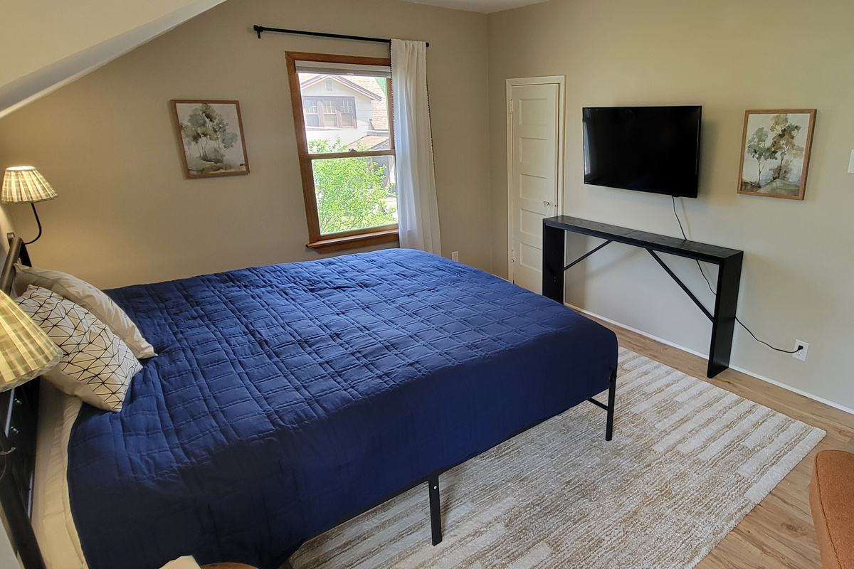 Main bedroom with TV and two closets for unpacking and relaxing during your stay.