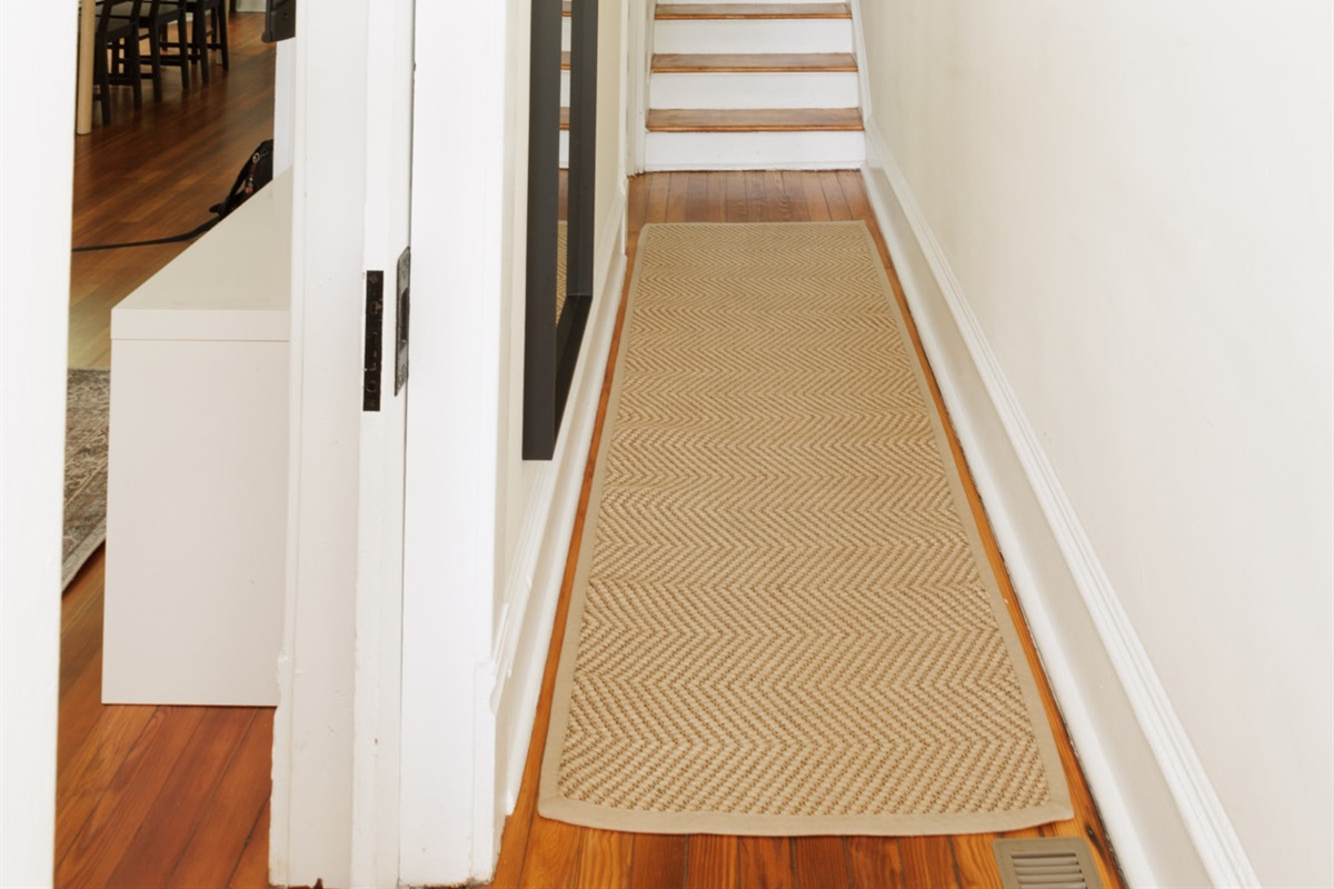 Entrance hallways leads into the living room, dining area, and stairs to the second floor.