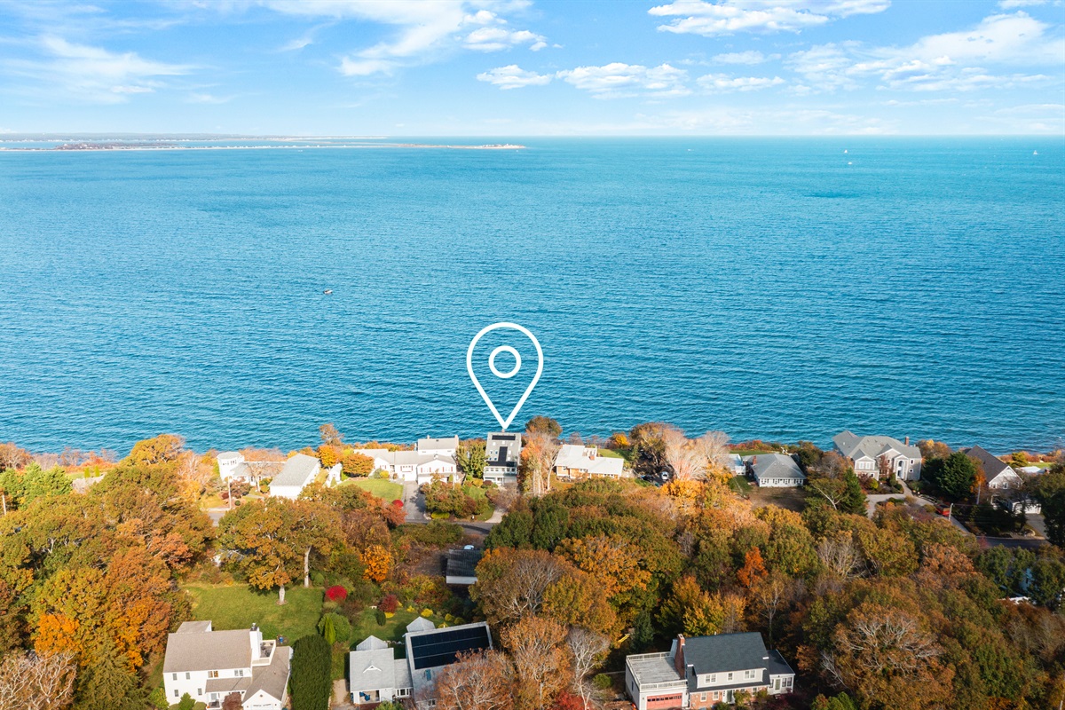 Aerial shot capturing the home and its breathtaking waterfront setting.