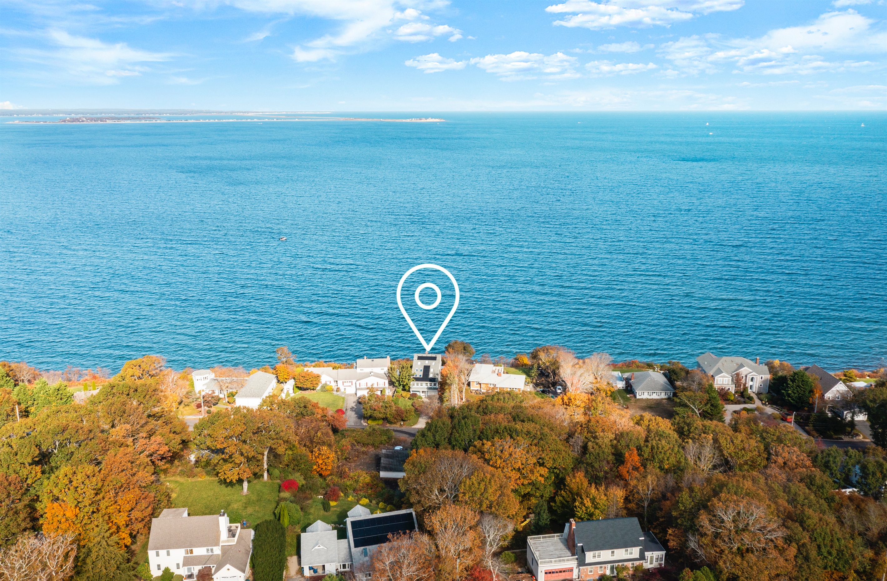 Aerial shot capturing the home and its breathtaking waterfront setting.