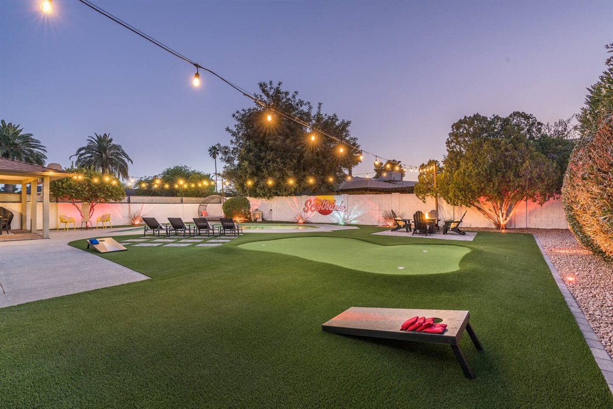 You won't want to leave the property once you set foot in the incredible back yard! Large pool with Baja step; covered patio with dining table; putting green; gas fire pit;  sun loungers; Giant Jenga; and corn hole.